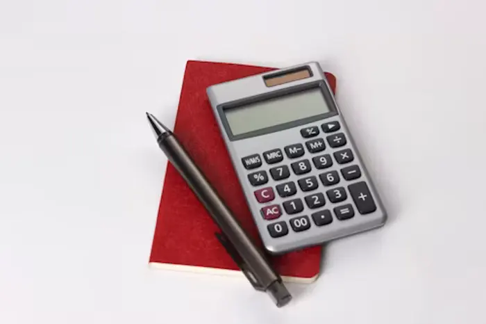Calculator and pen on a notebook